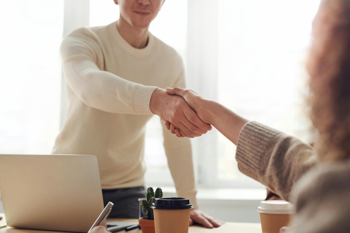 Handshake between client and company showing how to hire an app development agency