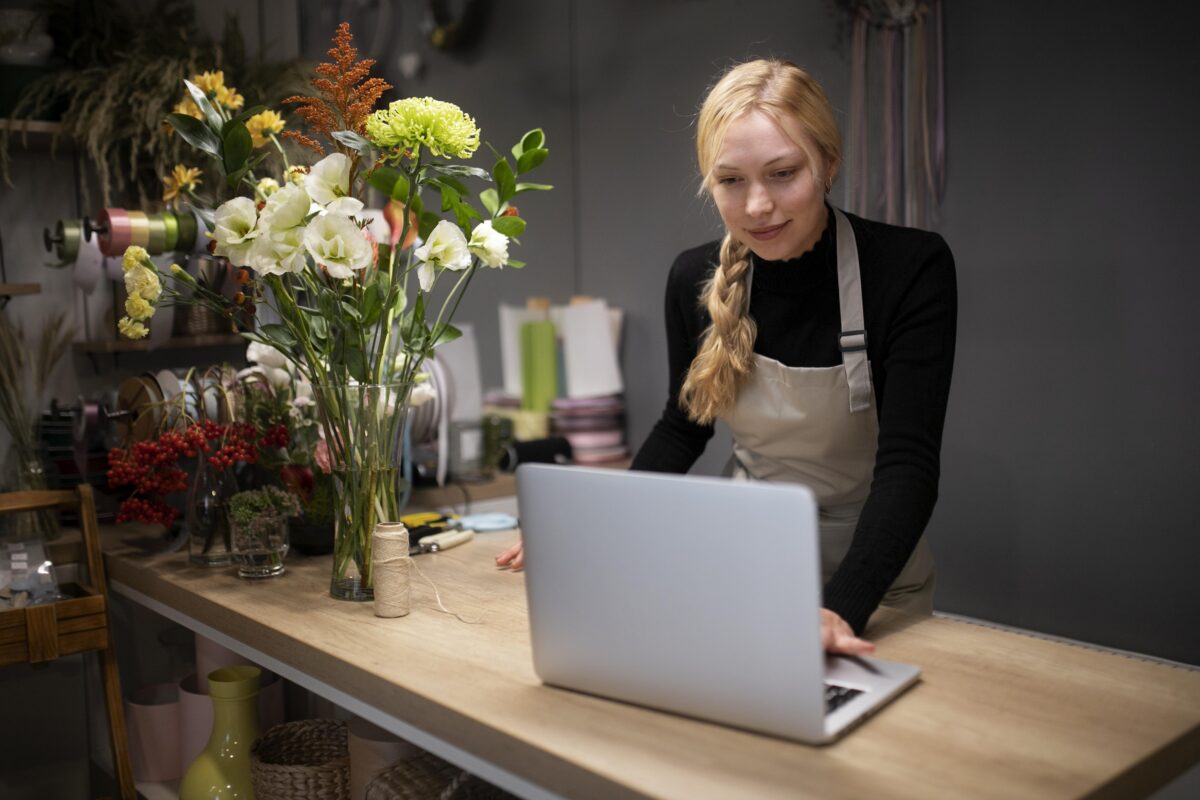 Florist working on laptop researching small business web development agencies