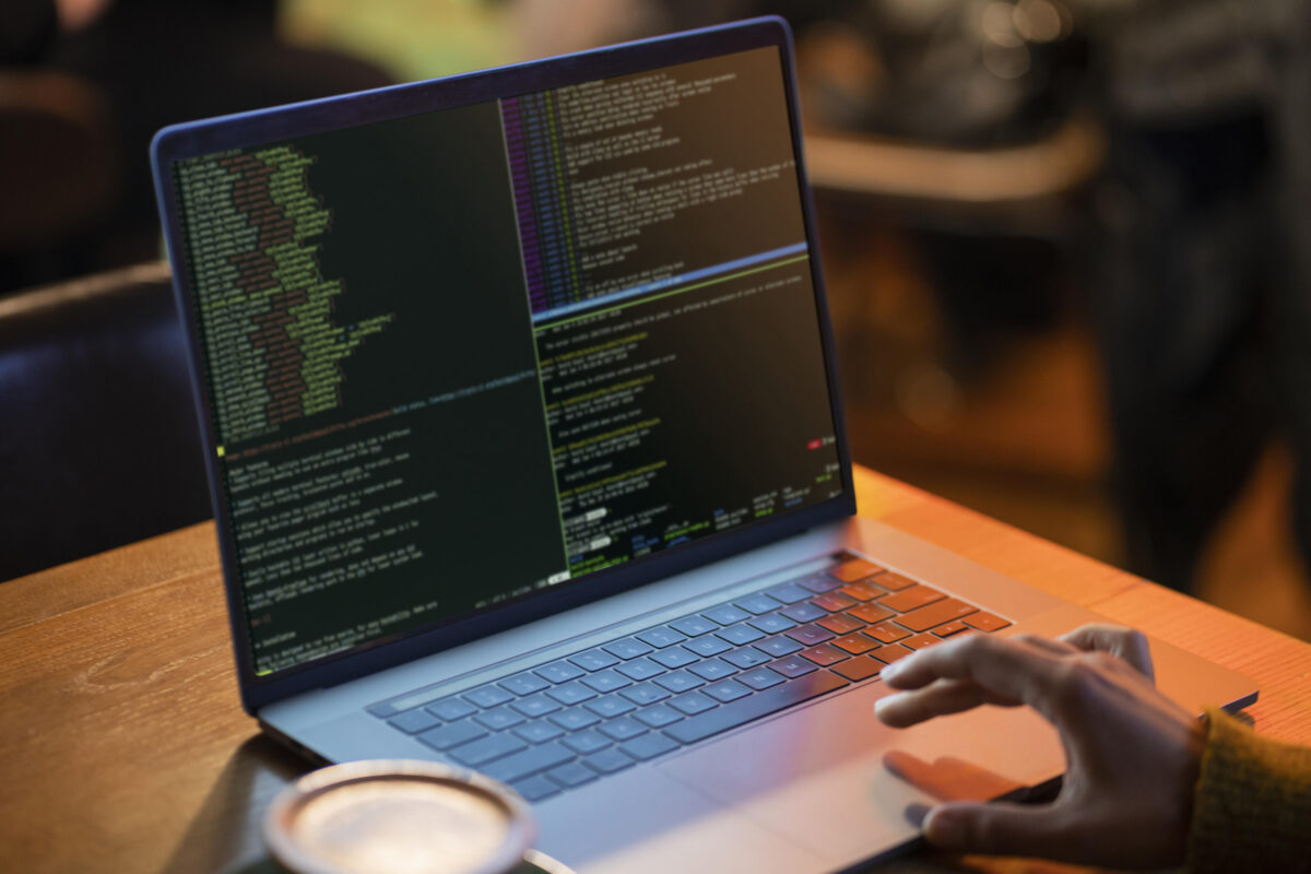 Developer coding on laptop screen, AngularJS web development companies building dynamic web applications